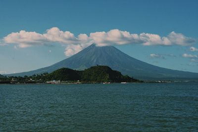 Scenic view of sea and mountains against sky