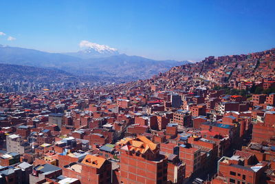 High angle view of townscape against blue sky