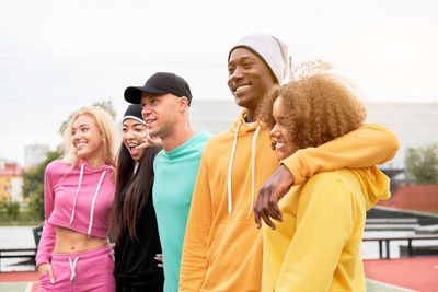 Cheerful friends standing outdoors