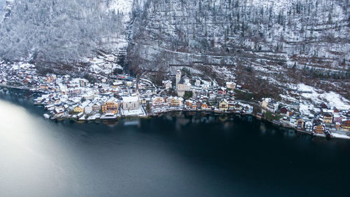 High angle view of buildings by city during winter