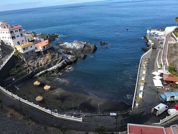 High angle view of buildings by sea