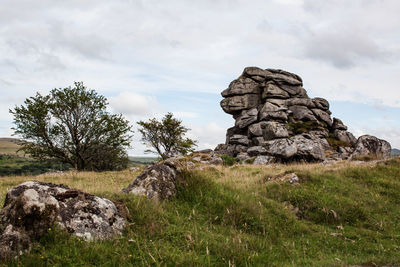 Rock formations on landscape against sky