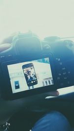 Man photographing car on windshield