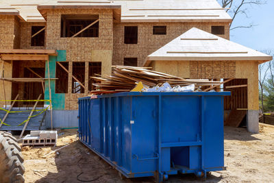 Stack of house on field against blue sky