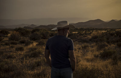 Silhouette of adult man standing on desert during sunset. almeria, spain