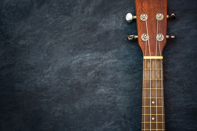 Close-up of guitar against black background