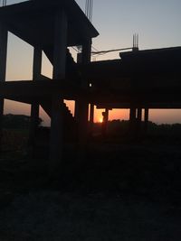 Built structure against sky at sunset