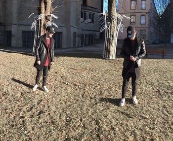 Full length of men standing in city