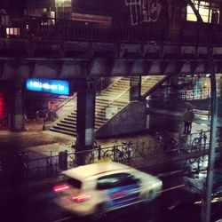 Cars in illuminated city at night