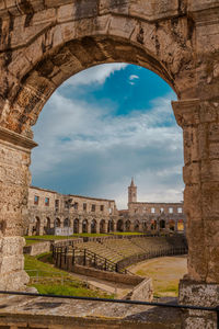 View of old ruin building against cloudy sky