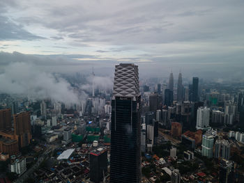 High angle view of buildings in city against sky