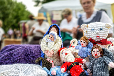 Crochet dolls made by elderly people for sale due to downsizing at a street stall.