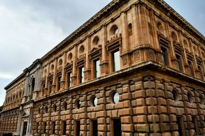 Low angle view of building against cloudy sky