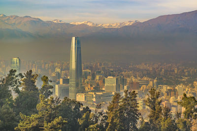 Panoramic view of buildings in city at sunset