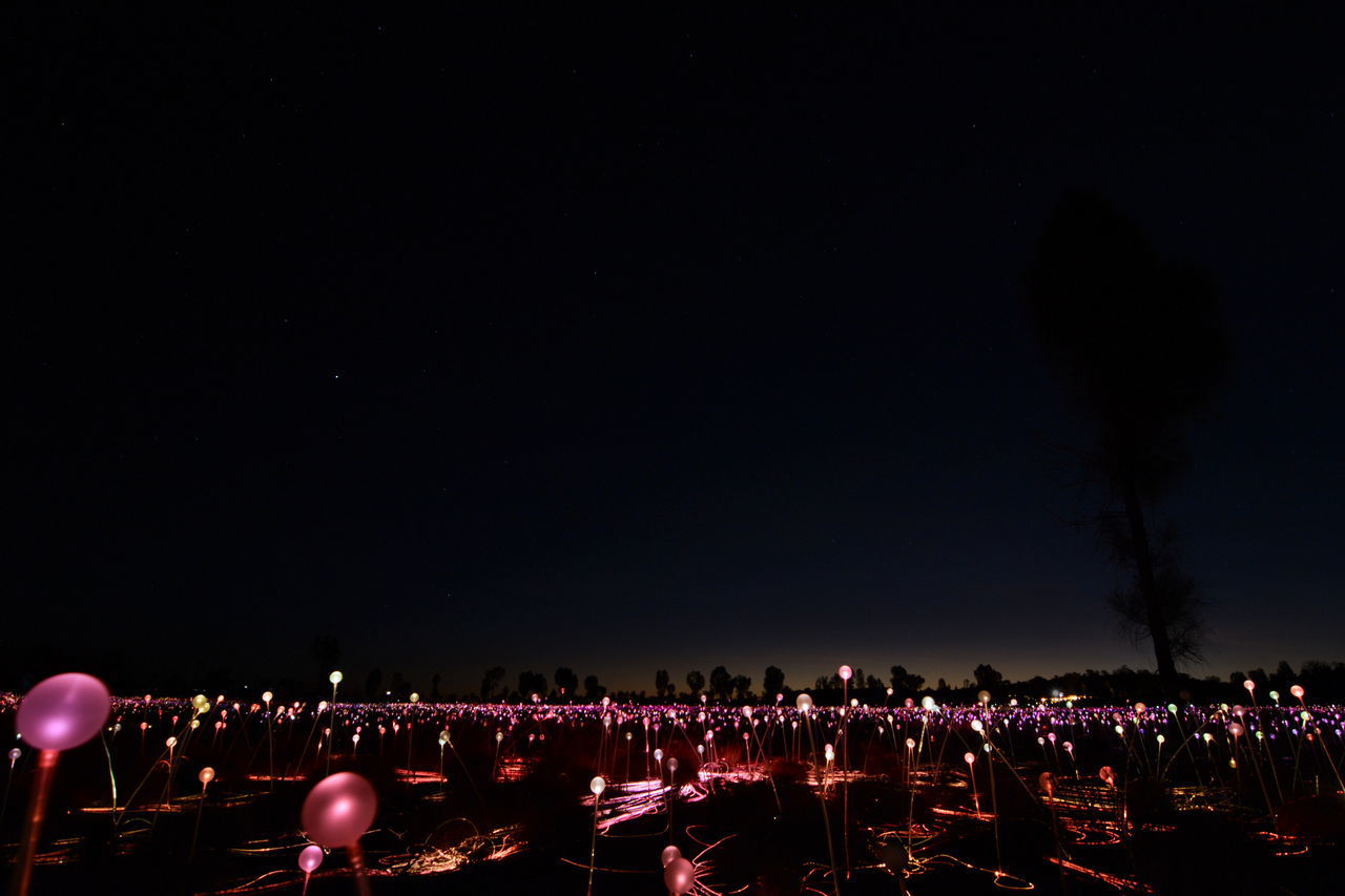 ILLUMINATED CITY AGAINST SKY AT NIGHT