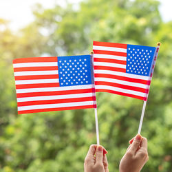 Midsection of person holding flag