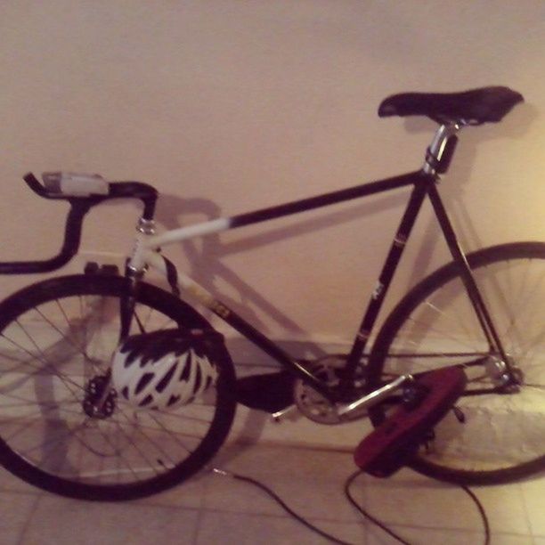 bicycle, land vehicle, mode of transport, transportation, stationary, wheel, parked, wall - building feature, parking, no people, close-up, shadow, wall, side view, day, metal, indoors, focus on foreground, sunlight