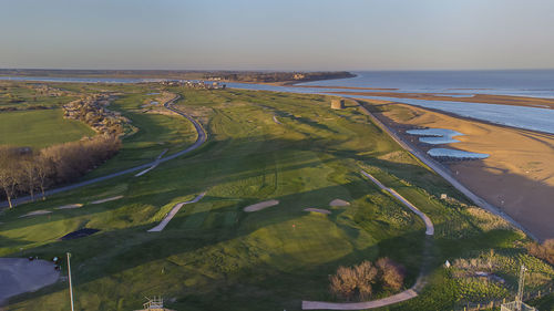 Drone point of view of a golf course by the coast in felixstowe, suffolk, uk