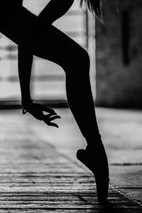 Low section of woman walking on street