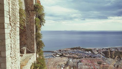 Panoramic shot of townscape by sea against sky