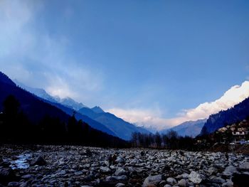 Scenic view of silhouette mountains against sky at sunset