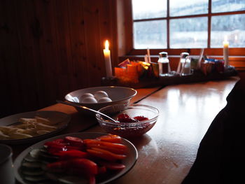 Close-up of breakfast on table against window