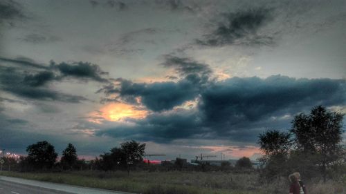 Scenic view of field against cloudy sky