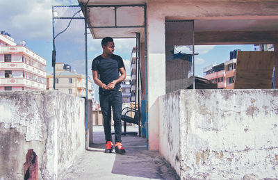 Young man standing on building terrace