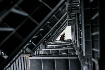 Low angle view of woman standing on railing