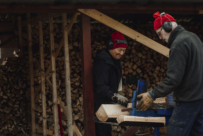 Senior couple using table saw