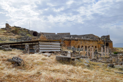 Old ruin on field against sky