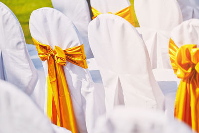 High angle view of chairs covered with white textiles