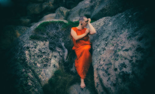 Full length of young woman on rock