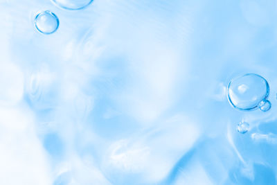 Close-up of bubbles against blue sky