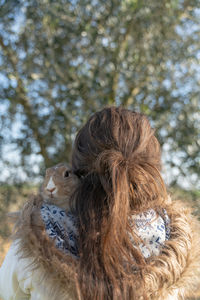 Close-up portrait of woman against tree