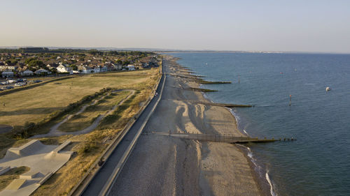 Aerial view of sea against clear sky