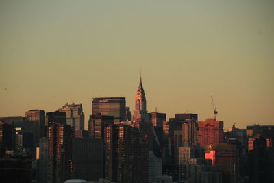 View of buildings against clear sky during sunset