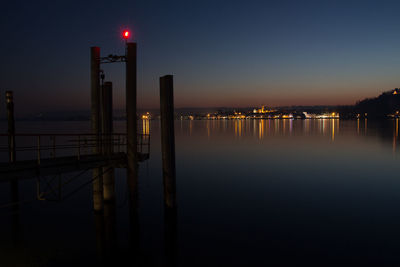 View of illuminated pier at night