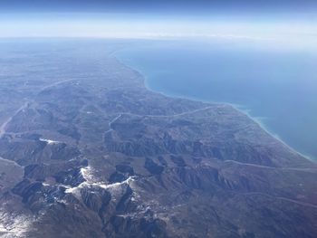 Aerial view of snowcapped mountains against sky