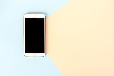 Close-up of smart phone over white background