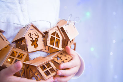 Midsection of woman holding paper toy