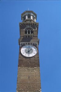 Low angle view of clock tower against clear blue sky