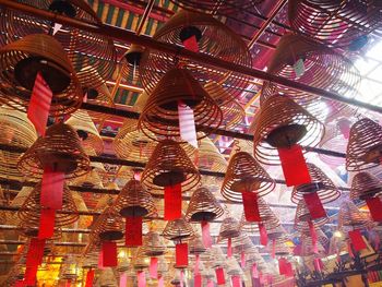 Low angle view of illuminated lanterns hanging in building