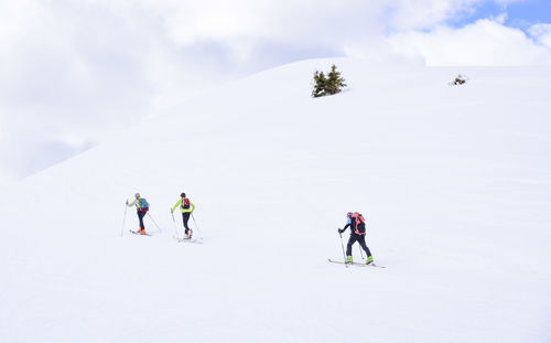 People skiing on snowcapped mountain