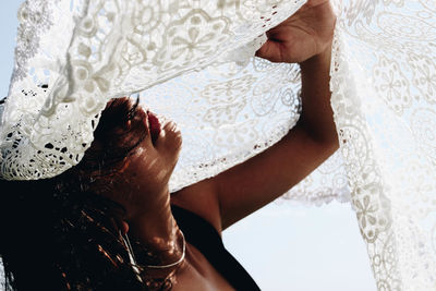 Close-up of woman hand on bed