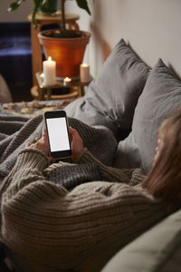 Woman lying in bed and using phone