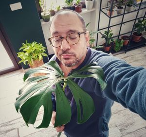 Portrait of man with potted plant