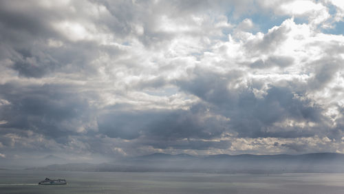 Scenic view of sea against storm clouds