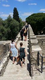 People on steps against sky