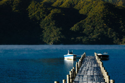 Pier over lake against sky